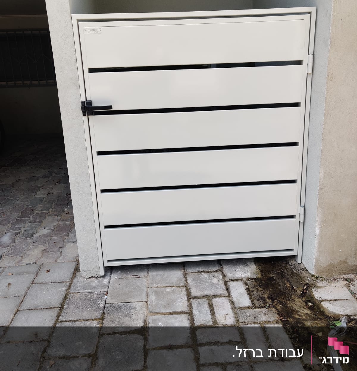 שער מתכת לבן עם פסים אופקיים שחורים